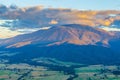 Aerial view of orange sunset light on beautiful mountain in Australian Alps. Royalty Free Stock Photo