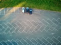 Aerial view of outdoor public parking lot with three cars parked on it Royalty Free Stock Photo