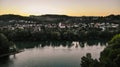 Aerial view over Aare river, to the church and residential area of Umiken and Riniken, Switzerland at sunset