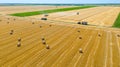 Aerial view over agricultural fields in harvest time, season, round bales of straw over harvested field Royalty Free Stock Photo