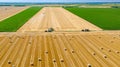 Aerial view over agricultural fields in harvest time, season, round bales of straw over harvested field Royalty Free Stock Photo
