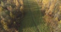 Aerial view over autumn rural landscape with field and forest in the morning Royalty Free Stock Photo