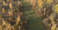 Aerial view over autumn rural landscape with field and forest in the morning Royalty Free Stock Photo