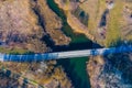 Aerial view over bridge on the small river and the forest, spring Sunny day, Central Russia Royalty Free Stock Photo