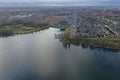 Aerial view over a city next to a lake in Europe with bare trees due to winter Royalty Free Stock Photo