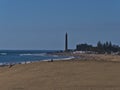 Aerial view over crowded beach Playa de Maspalomas with sand dune in front and lighthouse Faro de Maspalomas, Gran Canaria, Spain. Royalty Free Stock Photo