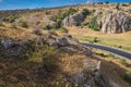 Aerial view over Dobrogei Gorges road and rock landscape - amazing landmark with blue sky and white clouds