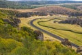 Aerial view over Dobrogei Gorges road and rock landscape - amazing landmark with blue sky and white clouds