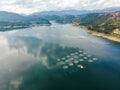 Aerial view over a fish farm with lots of fish enclosures on cages Royalty Free Stock Photo