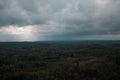 Aerial view over the green forest in evening. Cloudy mystery. Landscapes of Latvia. Royalty Free Stock Photo