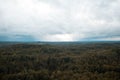 Aerial view over the green forest in evening. Cloudy mystery. Landscapes of Latvia. Royalty Free Stock Photo