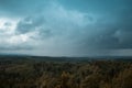 Aerial view over the green forest in evening. Cloudy mystery. Landscapes of Latvia. Royalty Free Stock Photo