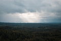 Aerial view over the green forest in evening. Cloudy mystery. Landscapes of Latvia. Royalty Free Stock Photo
