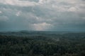 Aerial view over the green forest in evening. Cloudy mystery. Landscapes of Latvia. Royalty Free Stock Photo