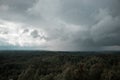 Aerial view over the green forest in evening. Rian over the forest. Cloudy mystery. Landscapes of Latvia. Royalty Free Stock Photo