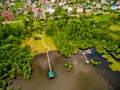 Aerial view over the houses, tree, lake.