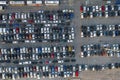 Aerial view over huge outdoor parking lots with many cars and vehicles