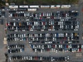 Aerial view over huge outdoor parking lots with many cars and vehicles