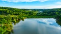 Aerial view over lake dam, weekend resort in woodland near water