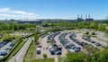 Aerial view over a large parking lot with many parked cars onto a football stadium and the Volkswagen factory