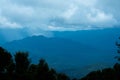 Aerial view over the mountains with sea of fog during morning sunrise in blue sky. Sea of clouds around mountain peaks at sunrise Royalty Free Stock Photo