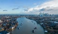Aerial view over River Thames and Canary Wharf in London - LONDON, UK - DECEMBER 20, 2022 Royalty Free Stock Photo