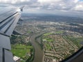 Aerial view over Thames river, London suburbs and Leg O\' Mutton Nature reserve, seen from airplane window