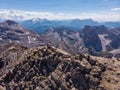 Aerial view over Tofana Di Mezzo peak in Dolomites. Climbers on top of the mountains. People silhouette on the summit. On the rid