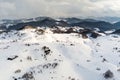 Aerial view over winter in the mountain village from Romania ,winter storm with low clouds and mist