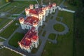 aerial view on overlooking restoration of the historic castle or palace in forest near lake or river