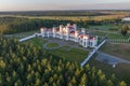 aerial view on overlooking restoration of the historic castle or palace in forest near lake or river