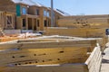 Packs of lumber at the natural materials from wood with roof rafters for building a house