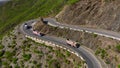 Aerial view of Pakistani Trucks on a Highway Road Winding through a Mountains, in Punjab, Khyber Pakhtunkhwa, Pakistan.