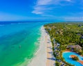 Aerial view of palms on the sandy beach of Indian Ocean at sunny day. Summer holiday in Zanzibar, Africa. Tropical landscape with Royalty Free Stock Photo