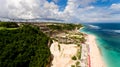 Aerial view of a Pandawa beach with many umbrellas and people relaxing.