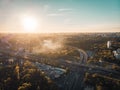 Aerial view panorama of Voronezh city from above at sunset, many buildings and roads with car traffic in evening myst