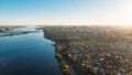 Aerial view panorama of Voronezh city from above at sunset, many buildings and roads with car traffic in evening myst