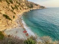 Aerial view of paradisiac Filikuri beach with red kayaks and turquoise blue water in Himare, Albania.