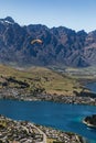 Aerial view of a paraglider over Queenstown, New Zealand with Lake Wakatipu under a blue sky Royalty Free Stock Photo