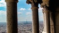 Aerial view of Paris France skyline and the Eiffel Tower against a cloudy blue sky