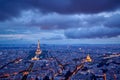 Aerial view of Paris rooftops and monuments illuminated Eiffel Tower and Les Invalides at twilight Royalty Free Stock Photo