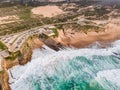 Aerial view of a parking lot and an endless road along the wild coastline in southern Portugal, view of Guincho beach and the Royalty Free Stock Photo