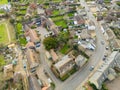 Aerial view of part of a typical English village, showing the main road snaking into the village High Street on the lower left. Royalty Free Stock Photo