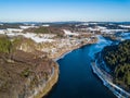 Aerial view of the partially frozen Lingese dam near Marienheide in winter.