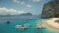 Aerial view of passenger boats with tourists rest at sea sand beach of Palawan island, Philippines Royalty Free Stock Photo