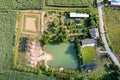 Aerial view pattern of mixed agriculture with house, plantation and pond in farmland