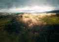 Aerial view of a peaceful valley with rolling fog over lush green trees. Saint-Donat, Quebec Royalty Free Stock Photo