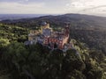 Aerial view of Pena Palace, a colourful Romanticist castle building on hilltop during a beautiful sunset, Sintra, Lisbon, Portugal Royalty Free Stock Photo