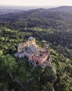 Aerial view of Pena Palace, a colourful Romanticist castle building on hilltop during a beautiful sunset, Sintra, Lisbon, Portugal Royalty Free Stock Photo