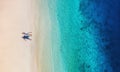 Aerial view of a people couple on the beach on Bali, Indonesia. Vacation and adventure. Beach and turquoise water. Top view from d Royalty Free Stock Photo